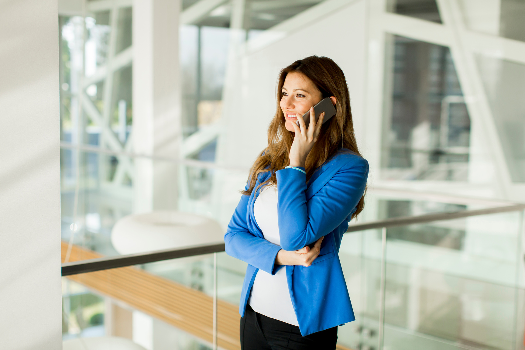 a person in a business suit talking on a cell phone