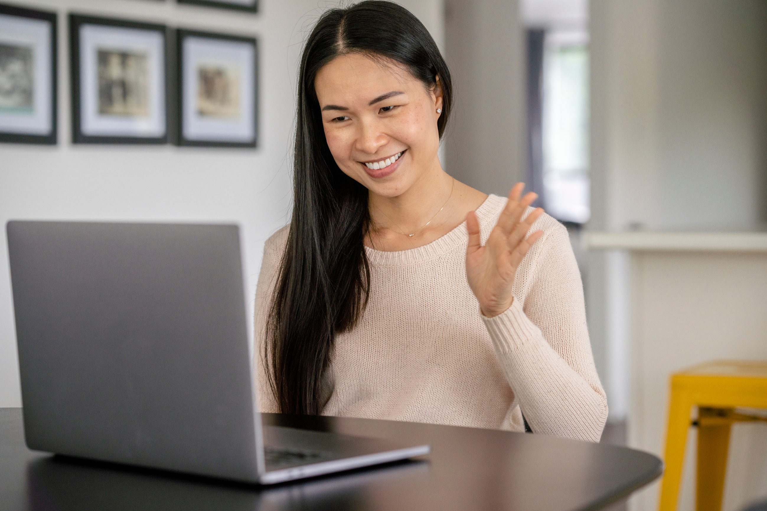 A person smiling while using a laptop computer