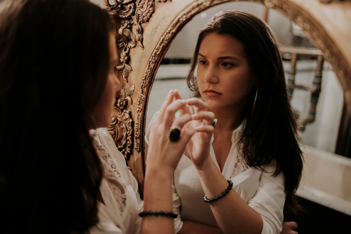 a woman reflecting in a mirror